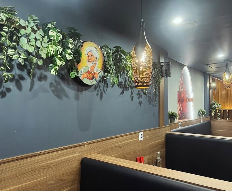 Painted mural and trailing plants along the booths